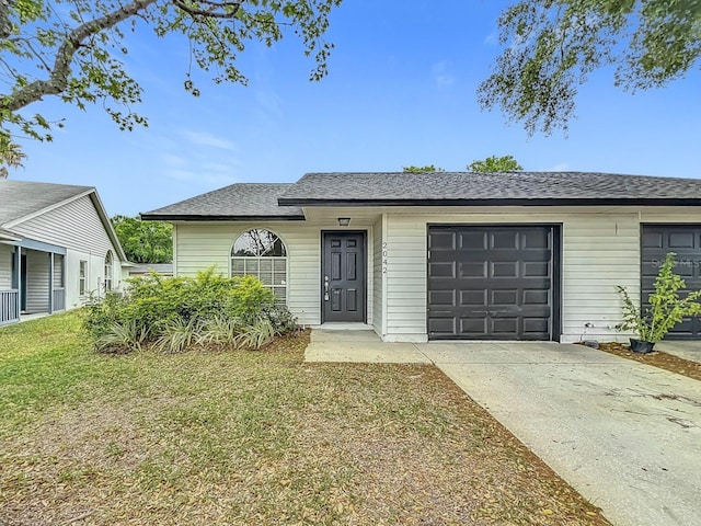 2042 Windward Pass, Lakeland, FL 33813 - ranch-style house featuring a front yard, concrete driveway, a shingled roof, and an attached garage
