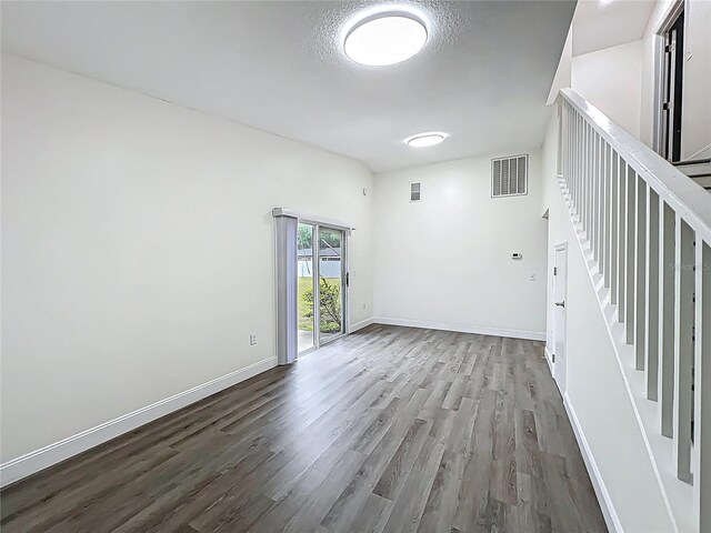 2042 Windward Pass, Lakeland, FL 33813 - spare room featuring baseboards, visible vents, wood finished floors, and stairway