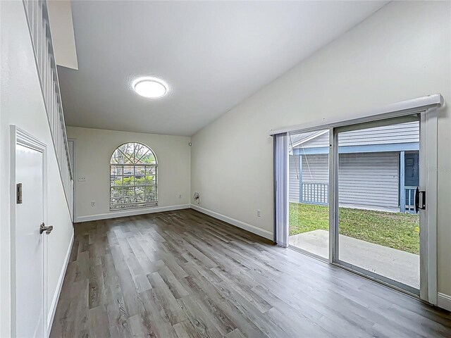 2042 Windward Pass, Lakeland, FL 33813 - unfurnished room with baseboards, vaulted ceiling, and wood finished floors