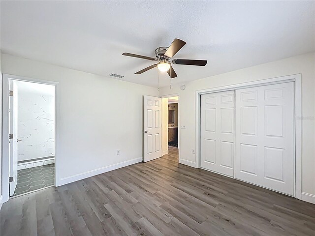 2042 Windward Pass, Lakeland, FL 33813 - unfurnished bedroom featuring a closet, visible vents, baseboards, wood finished floors, and ensuite bath
