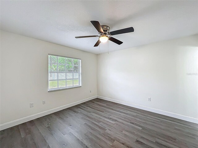 2042 Windward Pass, Lakeland, FL 33813 - empty room with a ceiling fan, dark wood-type flooring, baseboards, and a textured ceiling