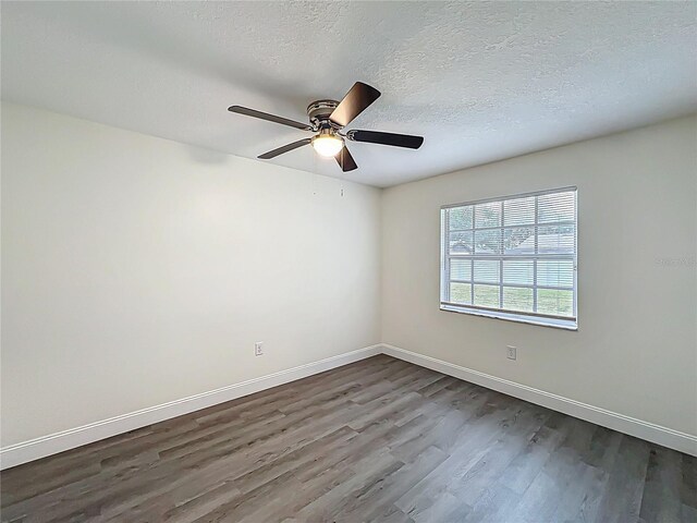 2042 Windward Pass, Lakeland, FL 33813 - spare room featuring dark wood-type flooring, a textured ceiling, baseboards, and ceiling fan