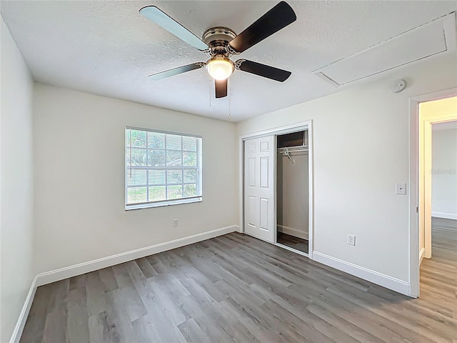 2042 Windward Pass, Lakeland, FL 33813 - unfurnished bedroom featuring attic access, wood finished floors, and a textured ceiling