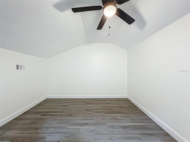 2042 Windward Pass, Lakeland, FL 33813 - additional living space with baseboards, vaulted ceiling, wood finished floors, and a textured ceiling