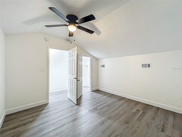 2042 Windward Pass, Lakeland, FL 33813 - bonus room with wood finished floors, a textured ceiling, lofted ceiling, and visible vents