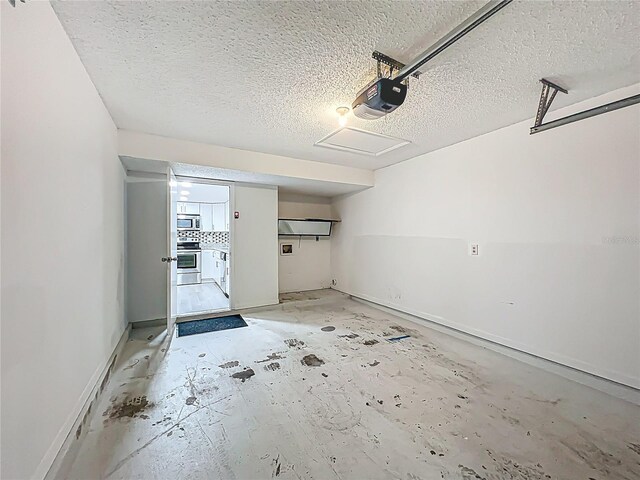 2042 Windward Pass, Lakeland, FL 33813 - garage with baseboards and a garage door opener