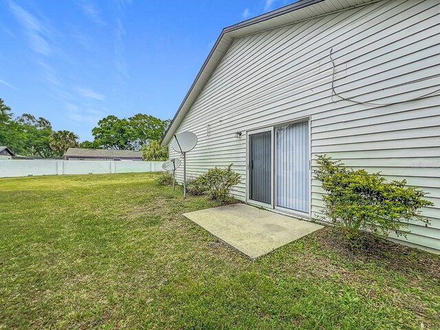 2042 Windward Pass, Lakeland, FL 33813 - rear view of property featuring fence and a lawn
