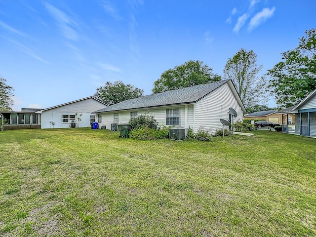 2042 Windward Pass, Lakeland, FL 33813 - rear view of house with cooling unit and a yard