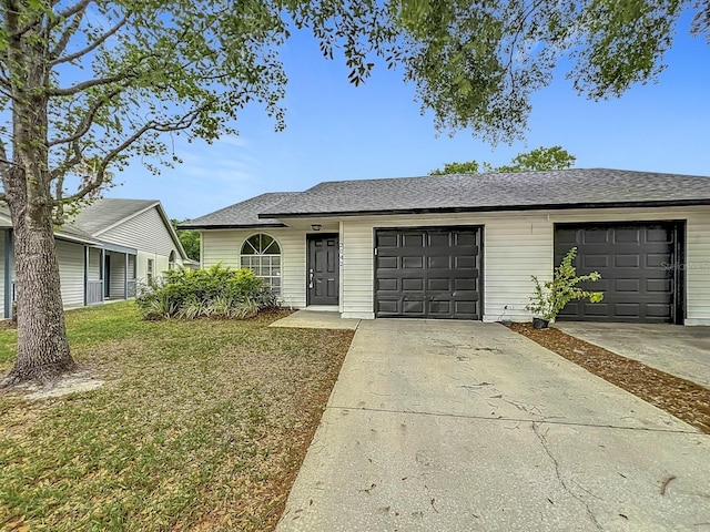 2042 Windward Pass, Lakeland, FL 33813 - ranch-style house with a garage, a front lawn, concrete driveway, and roof with shingles