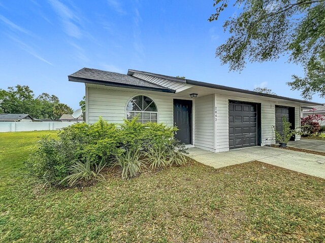 2042 Windward Pass, Lakeland, FL 33813 - view of front of house with a front yard, a garage, and concrete driveway