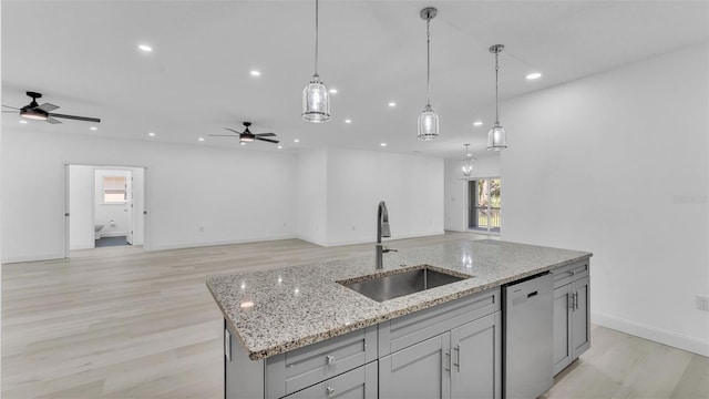 kitchen featuring a sink, dishwasher, ceiling fan, open floor plan, and light wood-style floors