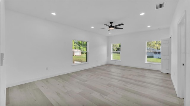 unfurnished room featuring light wood finished floors, plenty of natural light, and recessed lighting