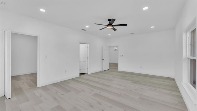 interior space with a ceiling fan, recessed lighting, baseboards, visible vents, and light wood-style floors