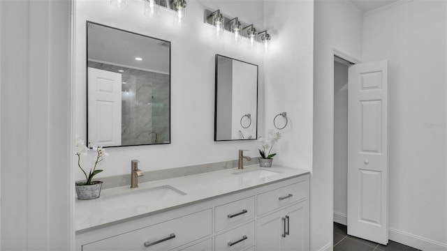 full bathroom featuring a tile shower, tile patterned floors, double vanity, and a sink