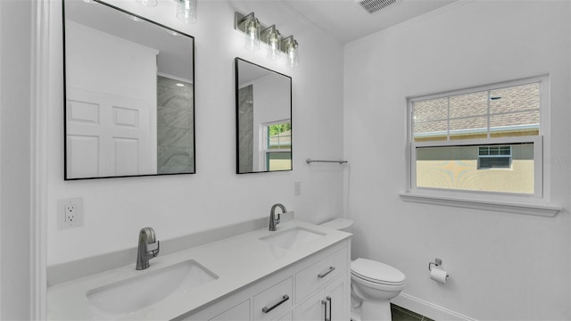 full bathroom featuring toilet, a wealth of natural light, visible vents, and a sink
