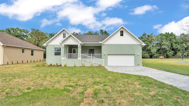 single story home with covered porch, a garage, decorative driveway, and a front yard