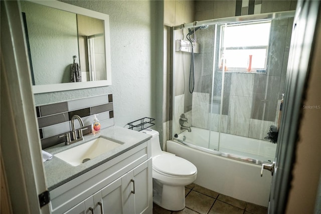 811 W Heron Pl, Winter Haven, FL 33884 - bathroom featuring a textured wall, vanity, bath / shower combo with glass door, and tile patterned flooring