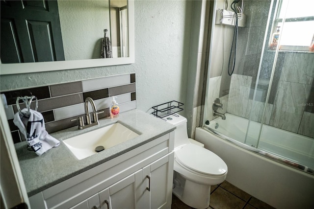 811 W Heron Pl, Winter Haven, FL 33884 - full bath with a textured wall, enclosed tub / shower combo, vanity, and tile patterned floors