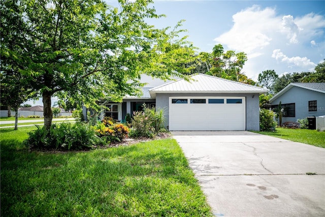 811 W Heron Pl, Winter Haven, FL 33884 - view of front of home with a garage, stucco siding, a front lawn, and concrete driveway