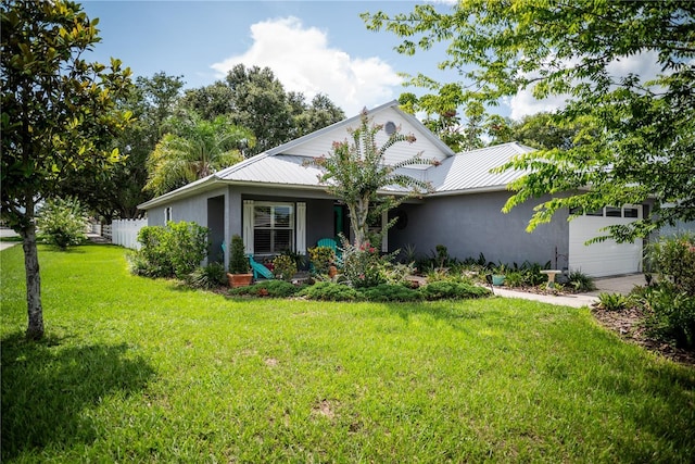 811 W Heron Pl, Winter Haven, FL 33884 - view of front of home featuring stucco siding, an attached garage, and a metal roof
