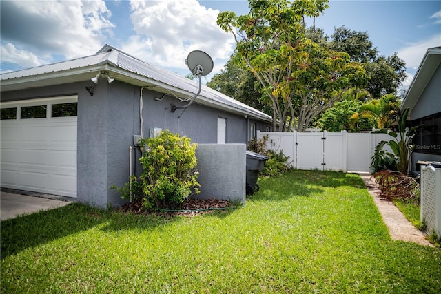 811 W Heron Pl, Winter Haven, FL 33884 - view of property exterior with stucco siding, a gate, a metal roof, and an attached garage