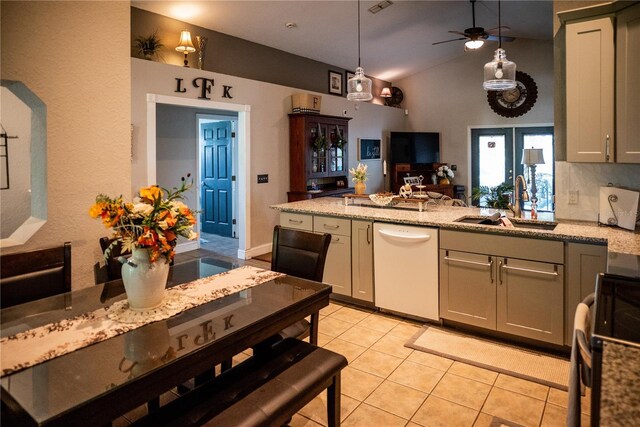 811 W Heron Pl, Winter Haven, FL 33884 - kitchen featuring white dishwasher, range with electric cooktop, light tile patterned floors, vaulted ceiling, and a peninsula