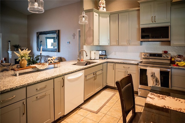 811 W Heron Pl, Winter Haven, FL 33884 - kitchen featuring stainless steel appliances, light tile patterned floors, pendant lighting, light stone counters, and a peninsula