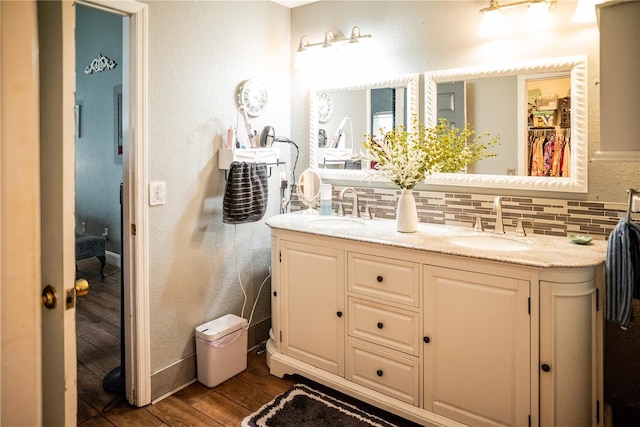 811 W Heron Pl, Winter Haven, FL 33884 - full bathroom with wood finished floors, double vanity, and backsplash