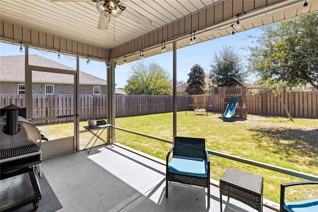unfurnished sunroom featuring a ceiling fan