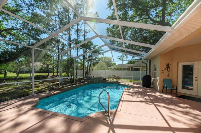 view of swimming pool featuring a patio area, a lanai, and a fenced in pool