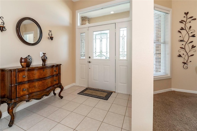 foyer with baseboards and light tile patterned flooring