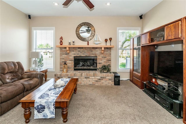 living room featuring carpet floors, a ceiling fan, a brick fireplace, and recessed lighting