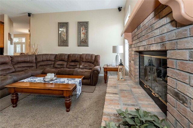 living area with baseboards and a fireplace