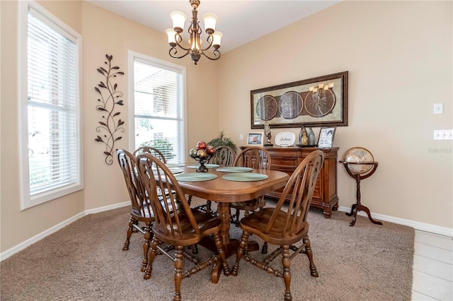 dining space featuring a wealth of natural light, baseboards, and a notable chandelier
