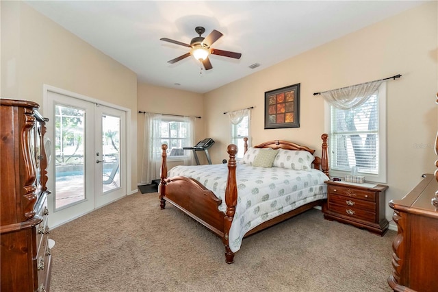bedroom featuring light carpet, french doors, visible vents, and access to outside