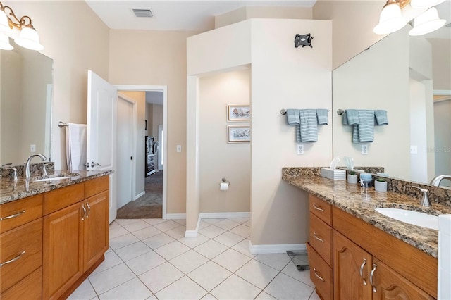 bathroom with two vanities, tile patterned floors, and a sink