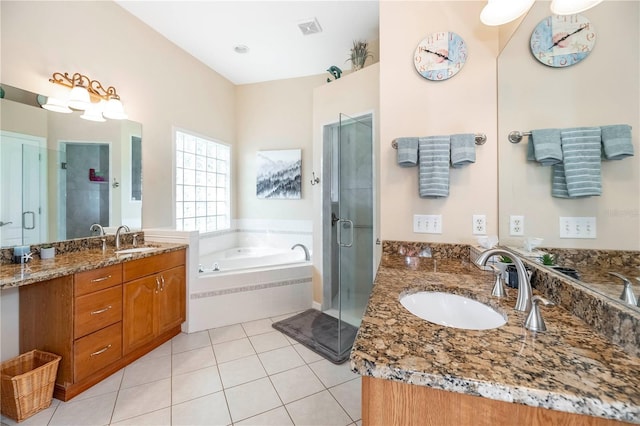bathroom featuring tile patterned floors, visible vents, a sink, and a stall shower
