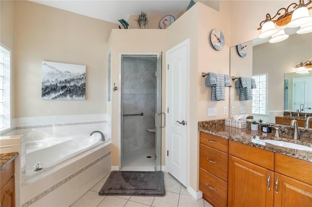 bathroom featuring a shower stall, a garden tub, vanity, and tile patterned floors