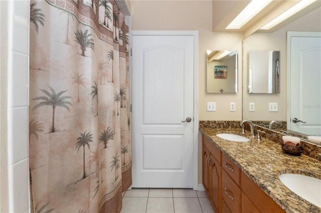 full bath featuring tile patterned flooring, a sink, and double vanity