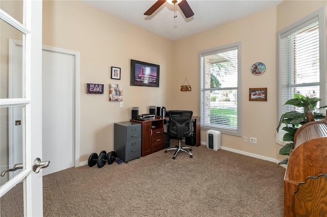 office space featuring carpet floors, a ceiling fan, and baseboards
