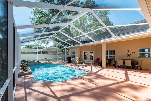view of pool featuring a fenced in pool, fence, glass enclosure, a patio area, and french doors
