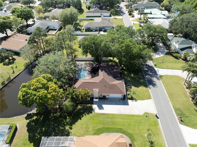 drone / aerial view with a water view and a residential view