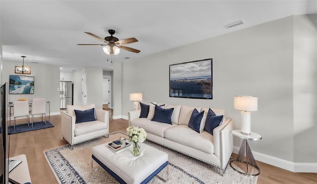 1650 W Mcleod St, Bartow, FL 33830 - living area featuring light wood-style flooring, a ceiling fan, and baseboards
