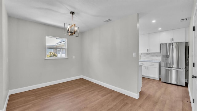 1650 W Mcleod St, Bartow, FL 33830 - unfurnished dining area featuring baseboards, light wood-style floors, a chandelier, and recessed lighting
