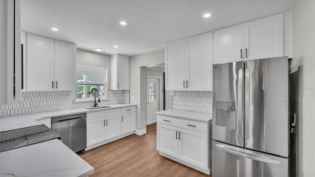 1650 W Mcleod St, Bartow, FL 33830 - kitchen with appliances with stainless steel finishes, a sink, tasteful backsplash, white cabinetry, and recessed lighting