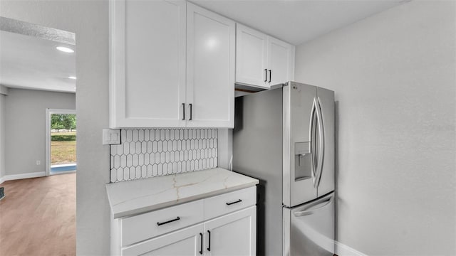 1650 W Mcleod St, Bartow, FL 33830 - kitchen featuring baseboards, stainless steel refrigerator with ice dispenser, white cabinetry, light stone counters, and recessed lighting