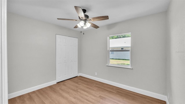 1650 W Mcleod St, Bartow, FL 33830 - unfurnished bedroom with baseboards, light wood-style floors, a closet, and a ceiling fan