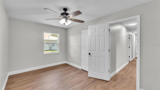 1650 W Mcleod St, Bartow, FL 33830 - unfurnished bedroom with light wood-style flooring, baseboards, a closet, and a ceiling fan