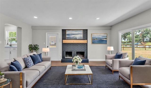 1650 W Mcleod St, Bartow, FL 33830 - living room with wood finished floors, recessed lighting, a fireplace, and baseboards