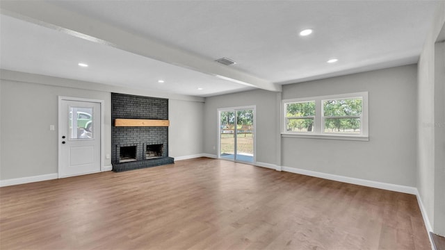 1650 W Mcleod St, Bartow, FL 33830 - unfurnished living room featuring wood finished floors, baseboards, a fireplace, recessed lighting, and beam ceiling
